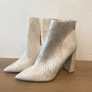 Sleek, white snake skin booties.